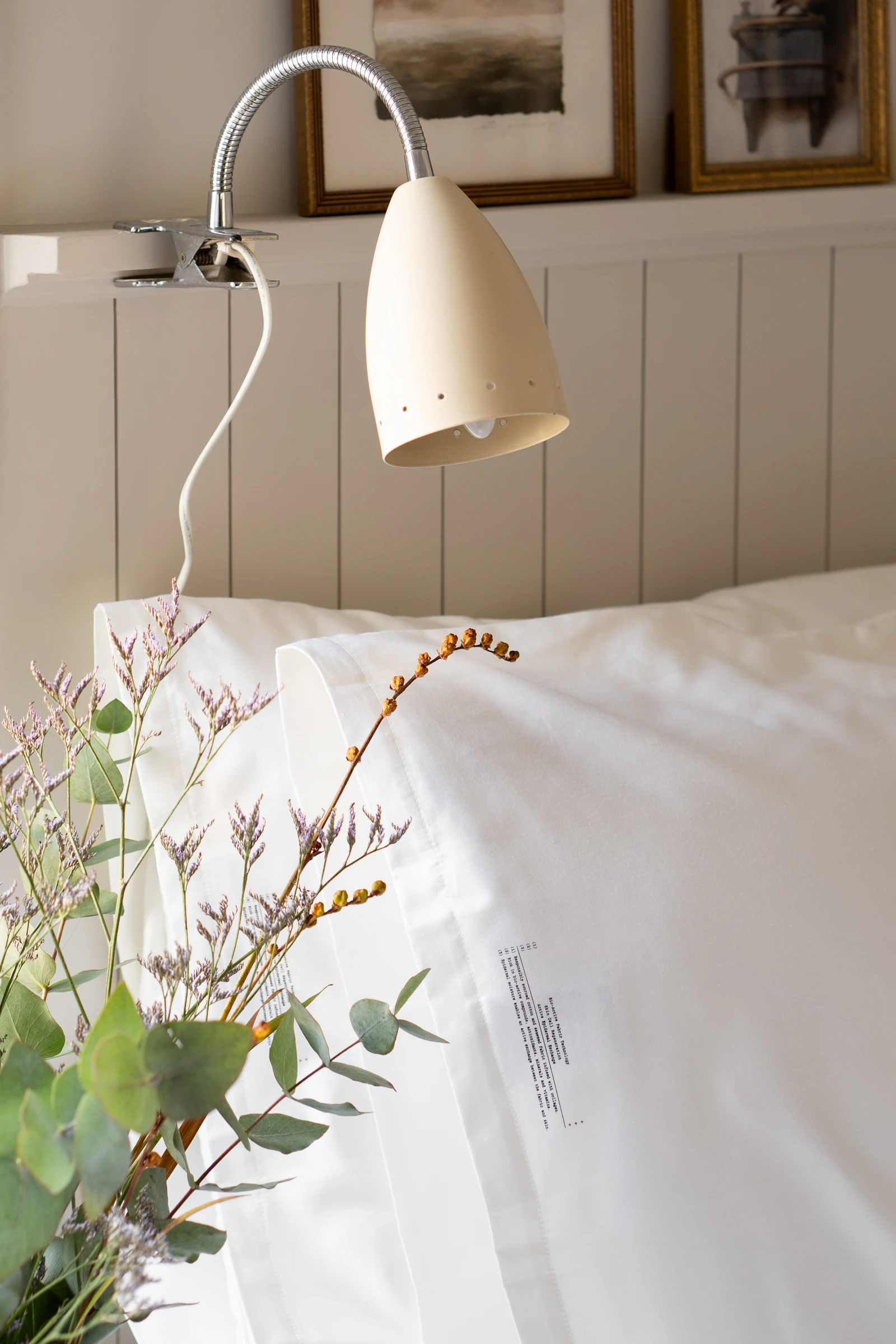 warm bedroom linen bedding ceramic lamp natural textures editorial