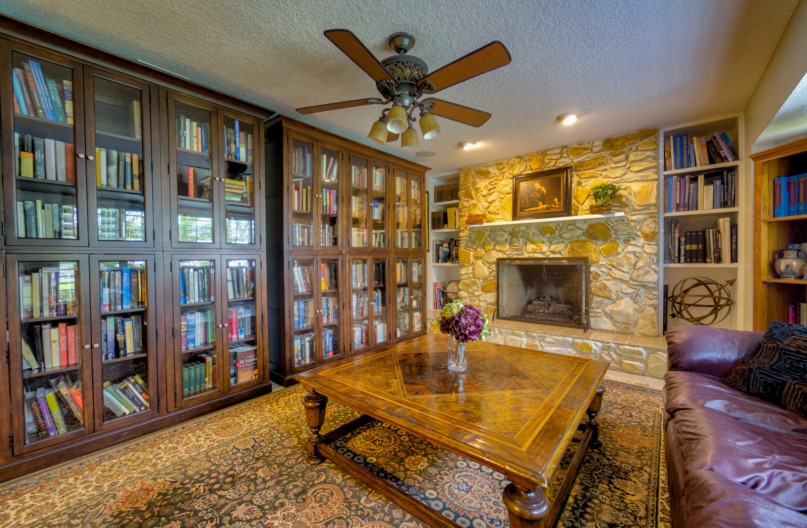Rustic elegant country home library with fireplace and leather furnishings