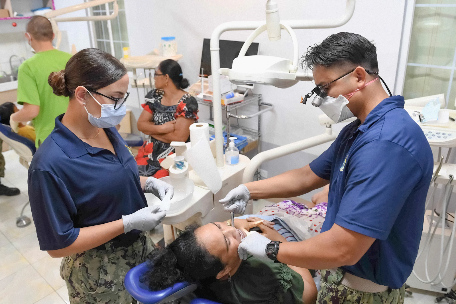Dr. in clinical attire, smiling confidently in modern dental practice