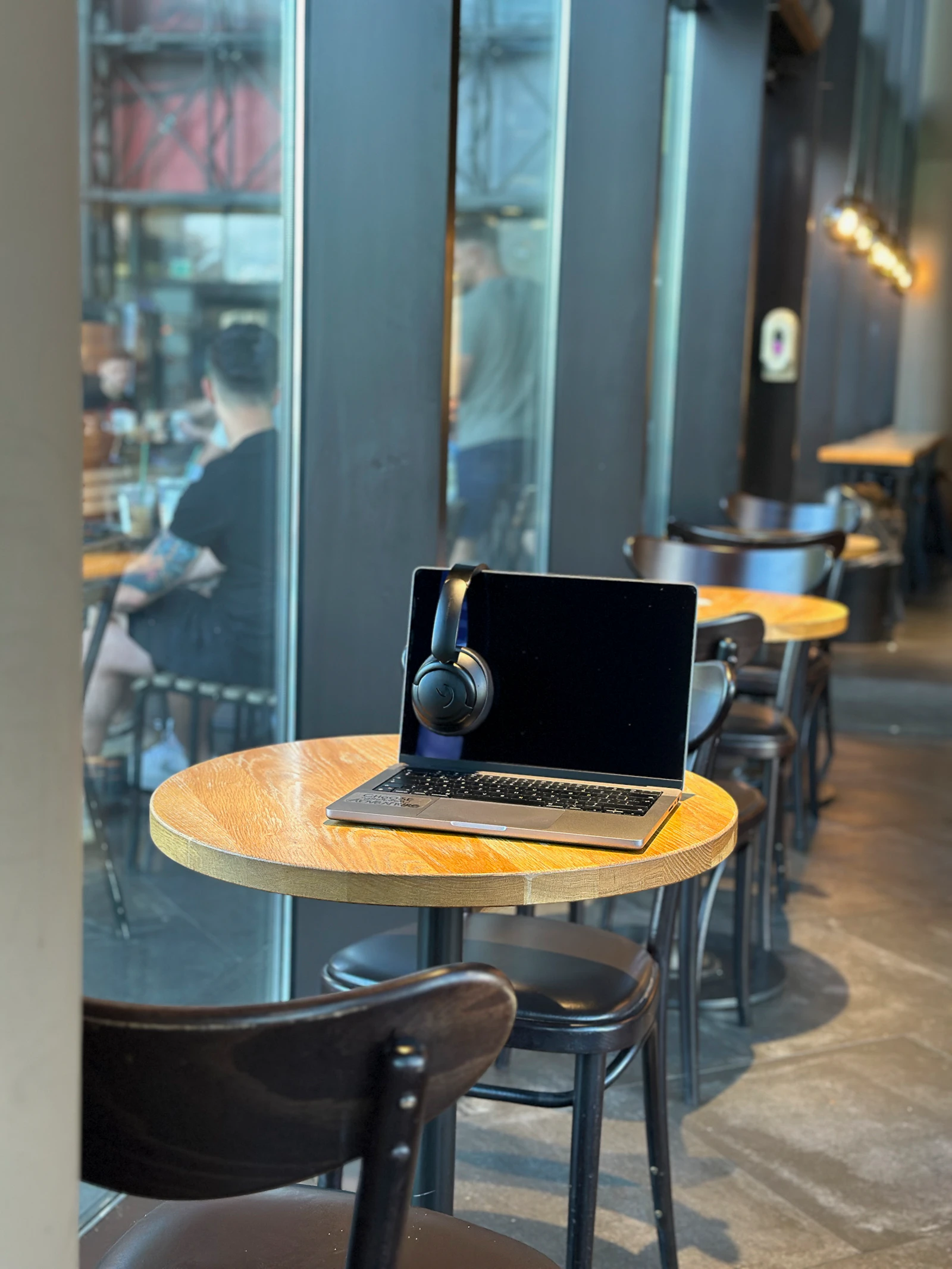 manager reviewing team schedule on laptop coffee shop
